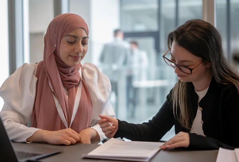 Two female WRS solicitors working together on document